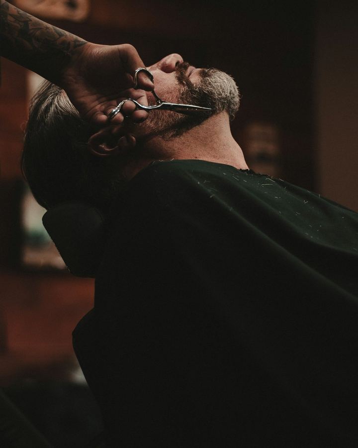 Close on the straight razor drawing the line at the jaw